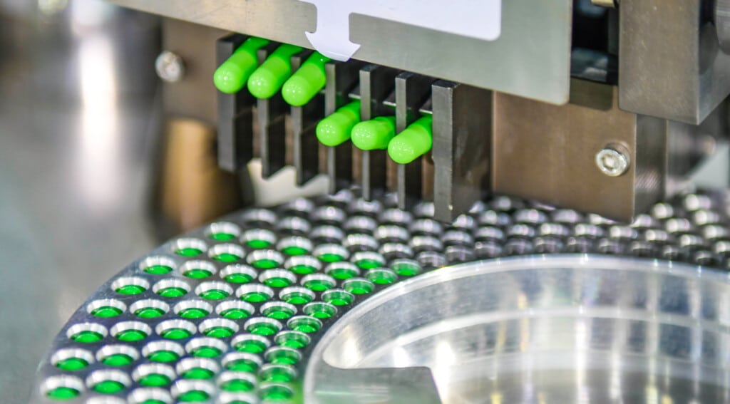 Green pills in a sorting machine